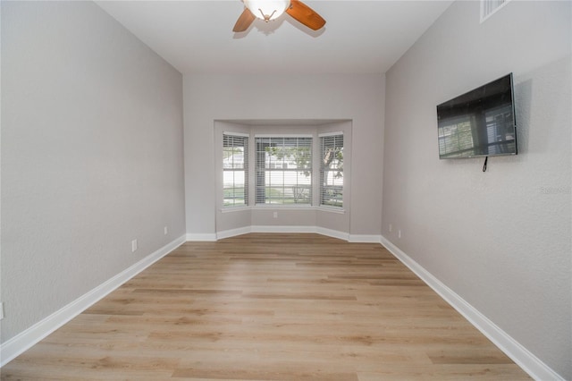 empty room featuring light wood-type flooring and ceiling fan