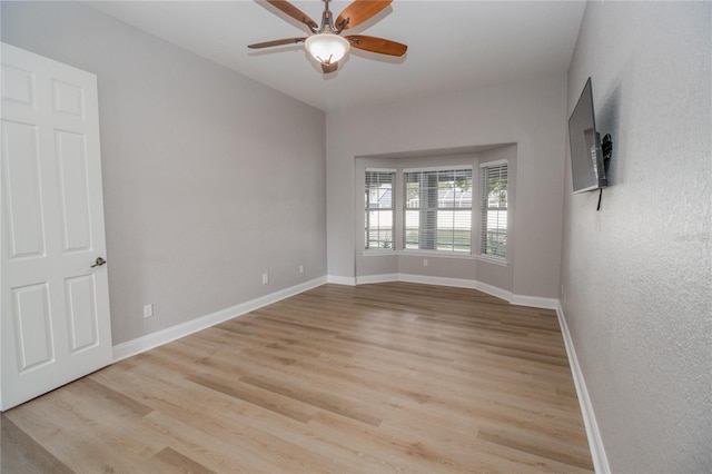 unfurnished room featuring light wood-type flooring and ceiling fan