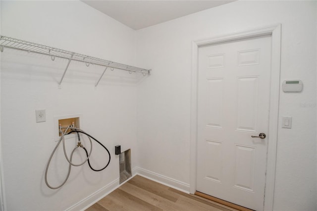 clothes washing area with hookup for an electric dryer, light hardwood / wood-style flooring, and washer hookup