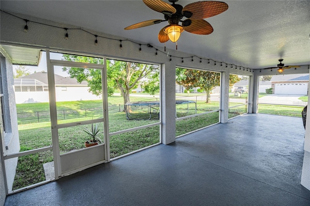 unfurnished sunroom with plenty of natural light and ceiling fan