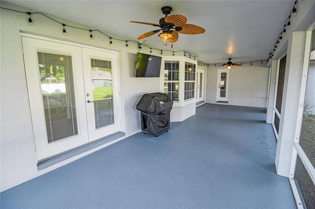 unfurnished sunroom featuring french doors and ceiling fan