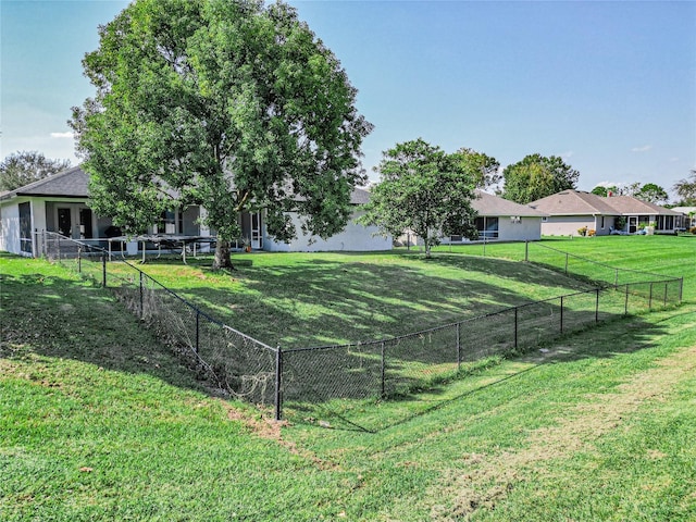 view of sport court with a lawn