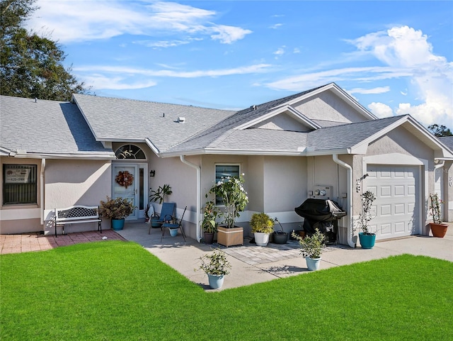 single story home featuring a front lawn and a garage