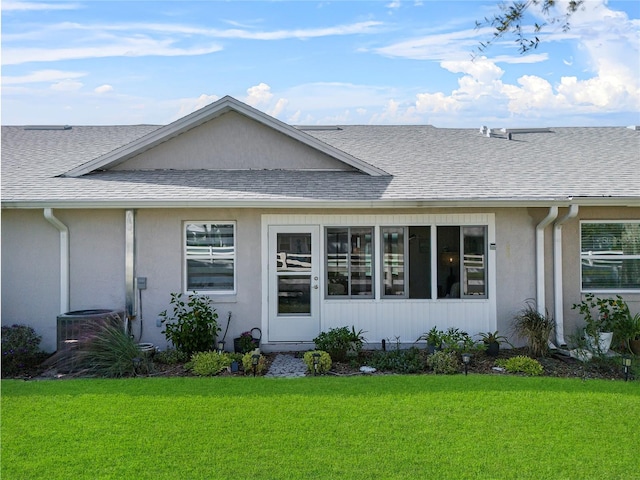 rear view of property featuring a yard