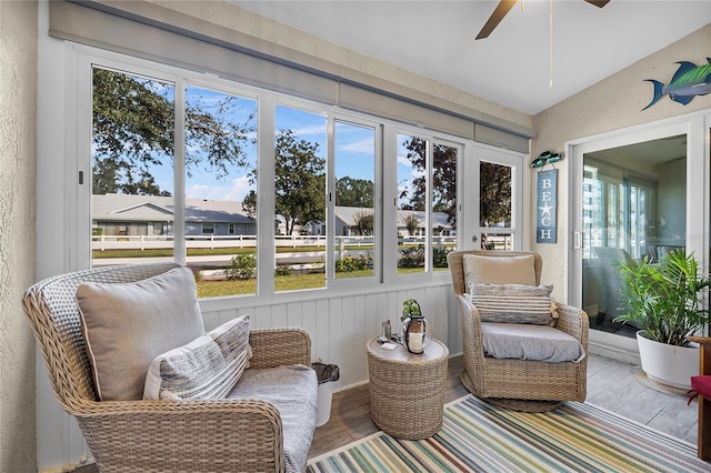 sunroom / solarium with a healthy amount of sunlight and ceiling fan