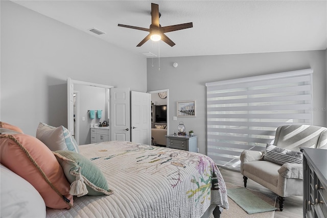 bedroom featuring ceiling fan, vaulted ceiling, and light wood-type flooring