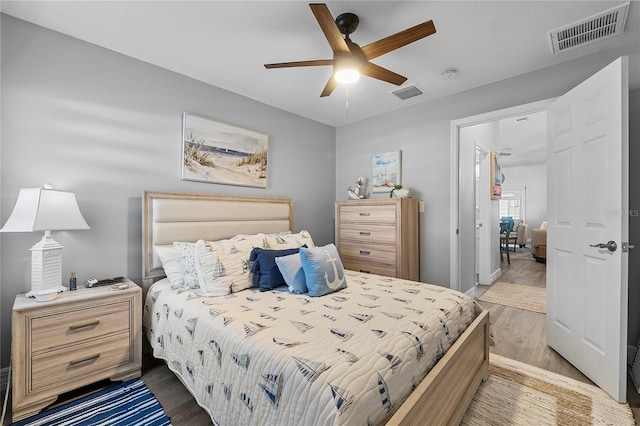 bedroom with hardwood / wood-style flooring and ceiling fan