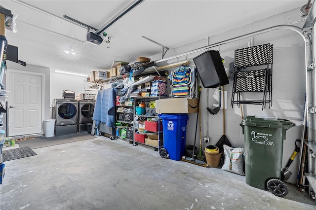 garage featuring a garage door opener and washer and dryer