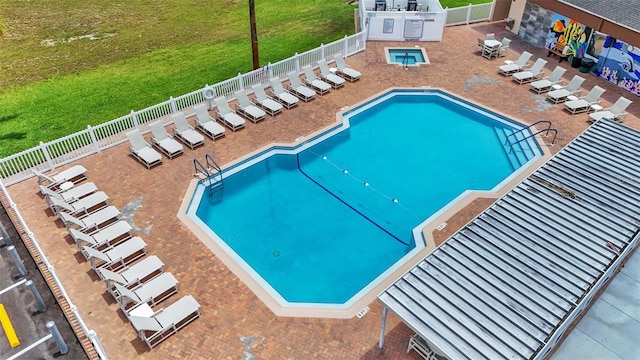 view of swimming pool with a yard and a patio area