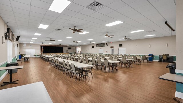 dining space featuring wood-type flooring and a paneled ceiling