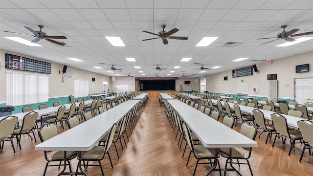 dining space with light hardwood / wood-style floors and a drop ceiling