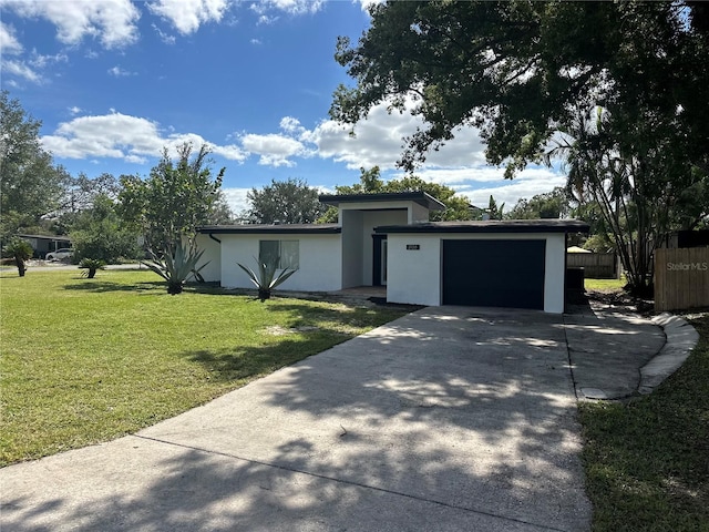 view of front of house with a front lawn and a garage