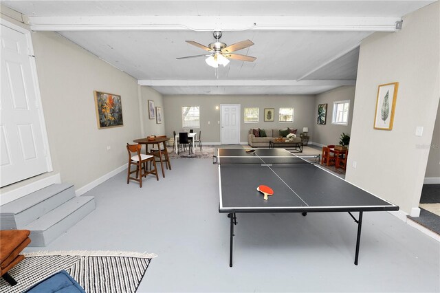 game room with ceiling fan, concrete floors, and beam ceiling