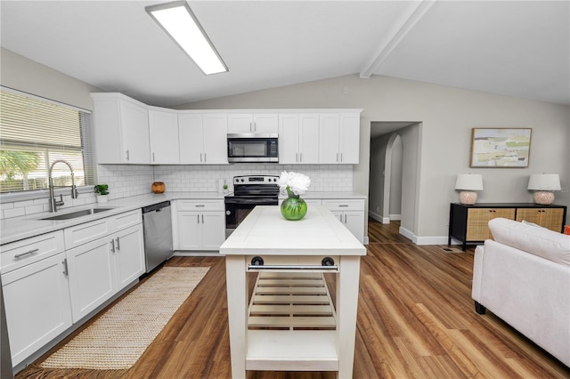 kitchen with appliances with stainless steel finishes, sink, and white cabinets