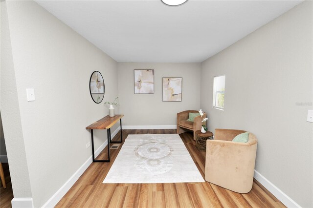 sitting room with wood-type flooring