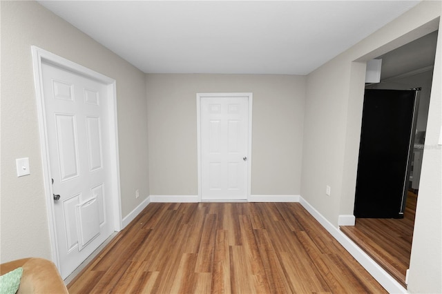 empty room with hardwood / wood-style flooring