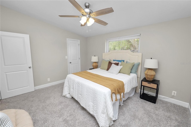 bedroom with lofted ceiling, light colored carpet, and ceiling fan