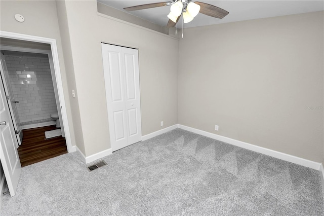 unfurnished bedroom with light carpet, a closet, and ceiling fan