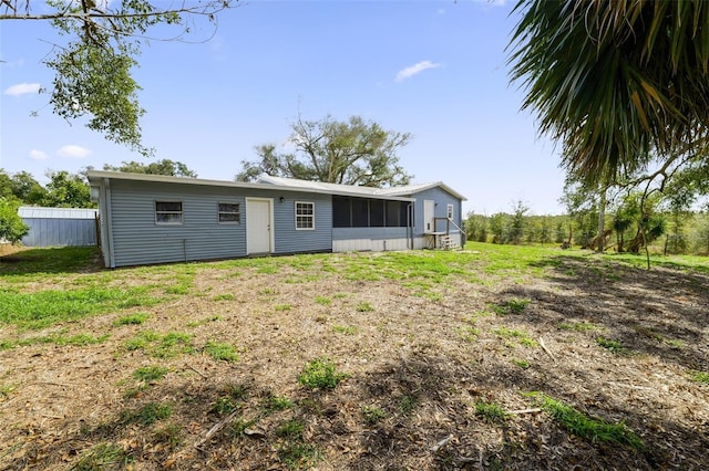 rear view of house featuring a lawn