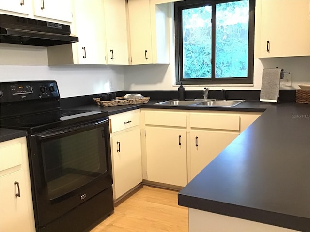 kitchen with light hardwood / wood-style flooring, white cabinetry, black range with electric cooktop, and sink