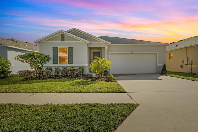 single story home with a yard and a garage