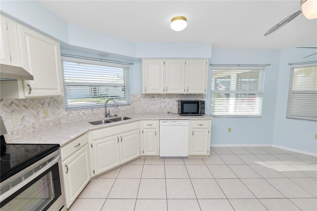 kitchen with white dishwasher, a wealth of natural light, sink, white cabinetry, and electric stove