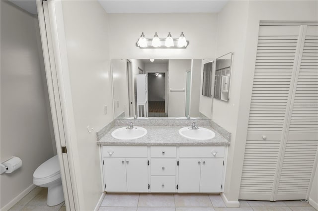 bathroom featuring vanity, toilet, and tile patterned flooring