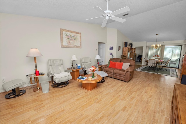 living room with vaulted ceiling, light hardwood / wood-style flooring, a textured ceiling, and ceiling fan with notable chandelier