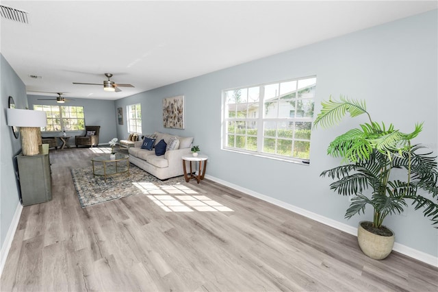 living room featuring light hardwood / wood-style floors and ceiling fan