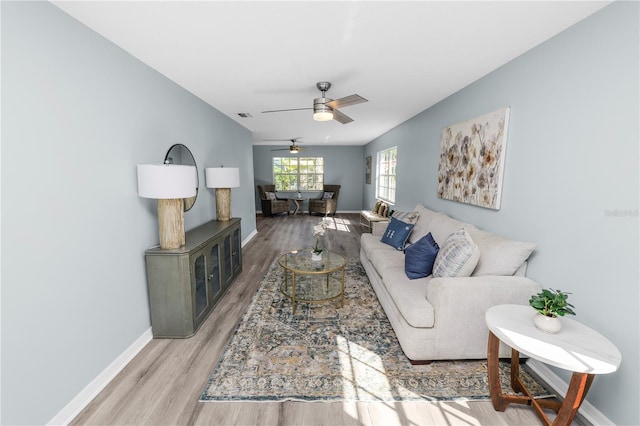 living room with ceiling fan and hardwood / wood-style flooring