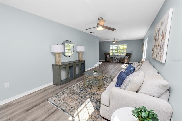 living room featuring ceiling fan, lofted ceiling, and hardwood / wood-style floors