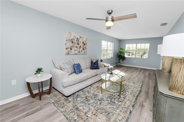 living room featuring hardwood / wood-style floors and ceiling fan