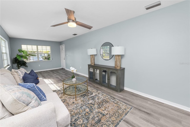 living room with wood-type flooring and ceiling fan