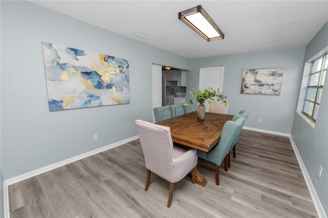 dining area with light wood-type flooring