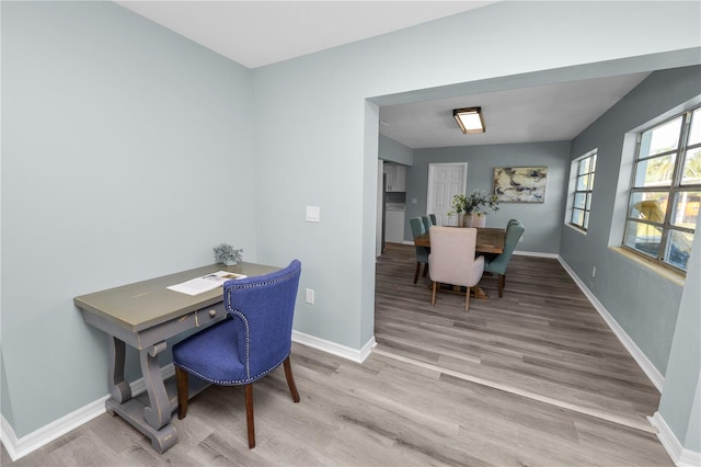 office area with light hardwood / wood-style floors