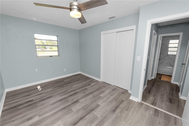 unfurnished bedroom with light hardwood / wood-style floors, a closet, and ceiling fan