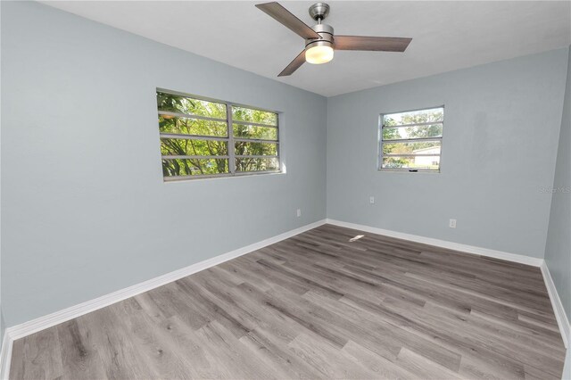 spare room with light hardwood / wood-style floors, plenty of natural light, and ceiling fan