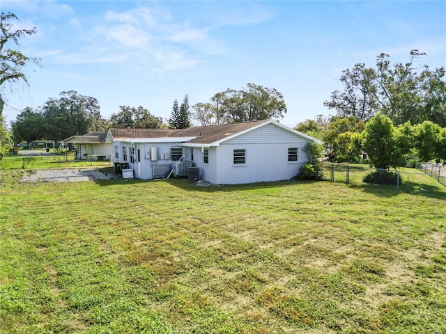 back of property featuring a yard