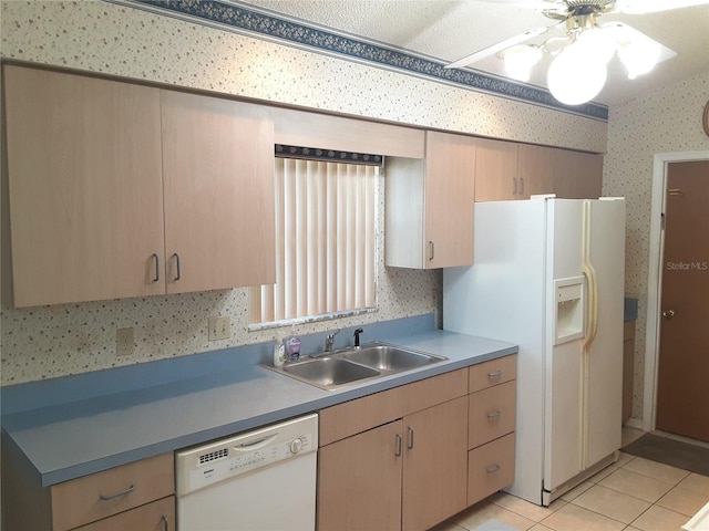 kitchen with sink, light brown cabinetry, ceiling fan, light tile patterned floors, and white appliances