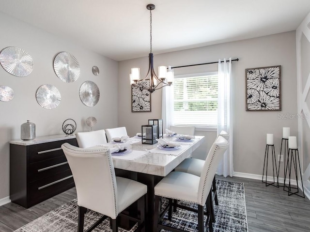 dining space featuring a chandelier and dark hardwood / wood-style flooring