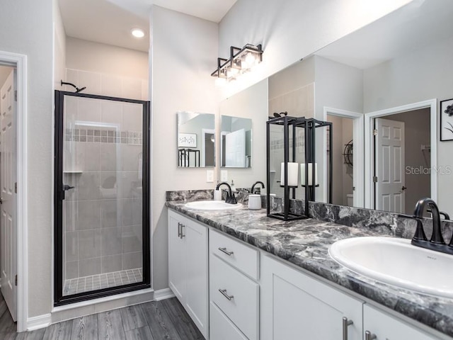 bathroom with vanity, hardwood / wood-style floors, and walk in shower