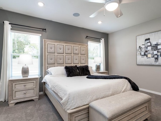 carpeted bedroom featuring multiple windows and ceiling fan