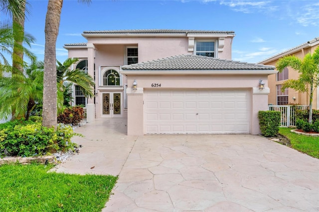 mediterranean / spanish-style house with a garage