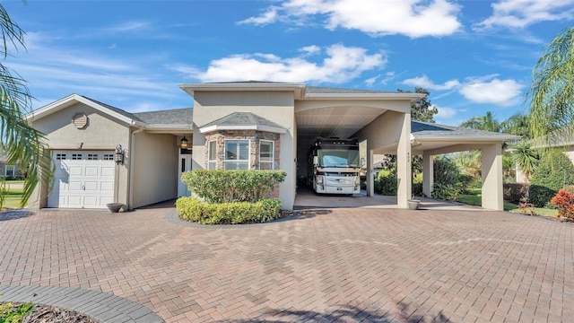 view of front facade with a garage and a carport