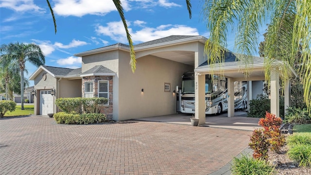 view of front of property with a garage and a carport