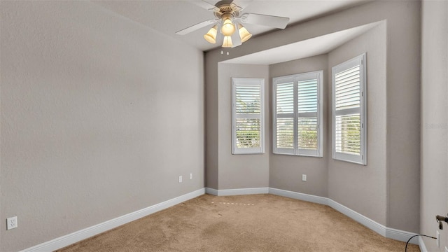 carpeted empty room with ceiling fan