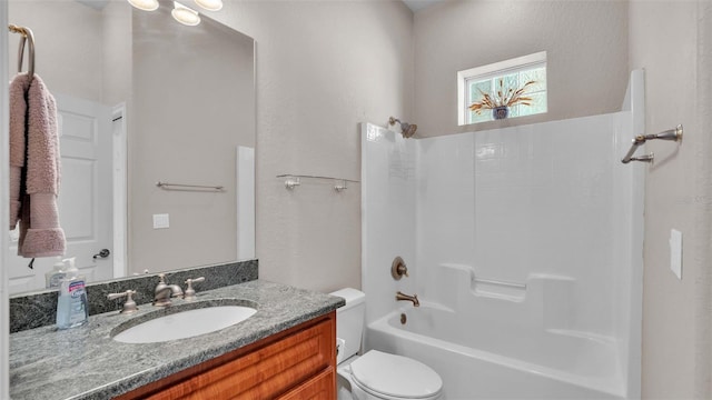 full bathroom with vanity, shower / tub combination, and toilet