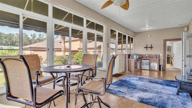 sunroom featuring ceiling fan and a healthy amount of sunlight