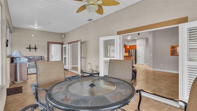 dining space with light tile patterned flooring and ceiling fan