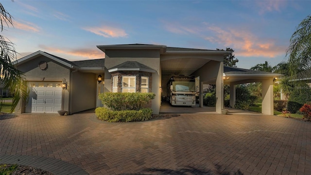 view of front of property featuring a garage and a carport